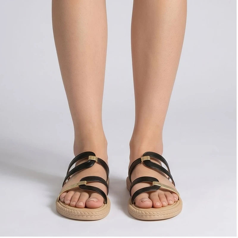Black and gold genuine leather slide sandals with tan soles.