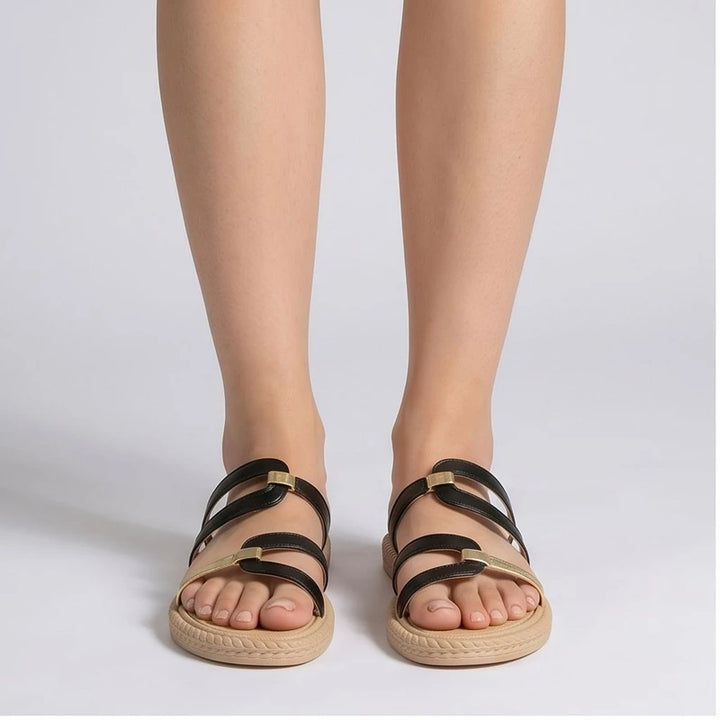 Black and gold genuine leather slide sandals with tan soles.