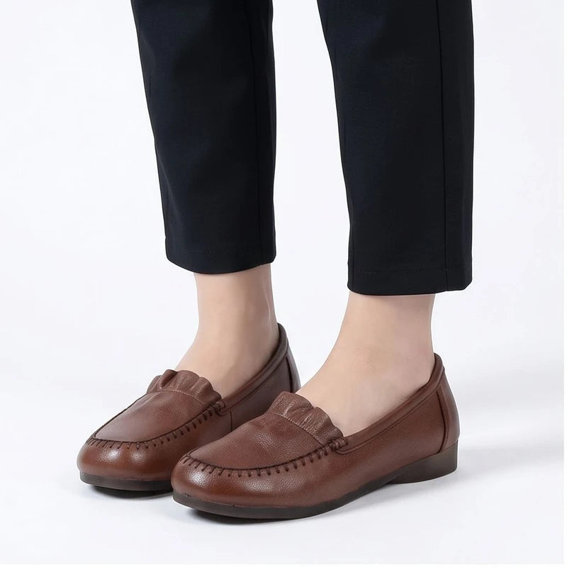 Model wearing Brown leather loafers in a studio
