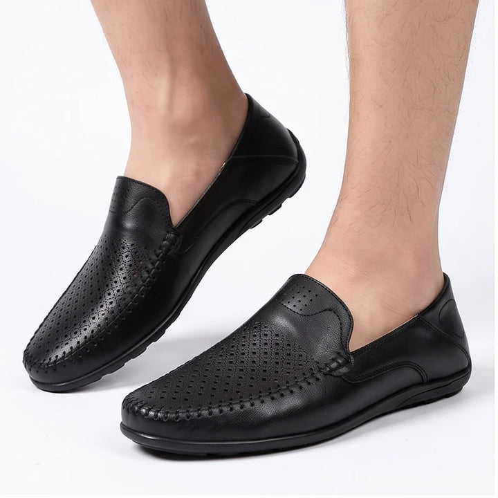 Model wearing Black leather loafers in a studio