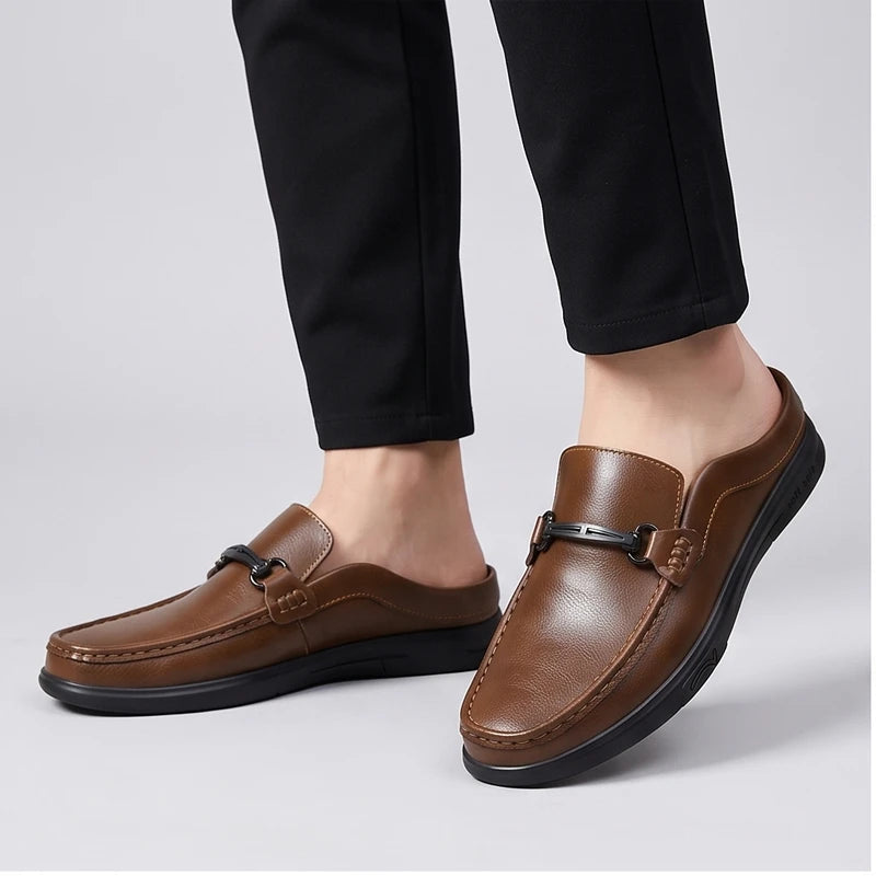 Model wearing Brown leather mules in a studio