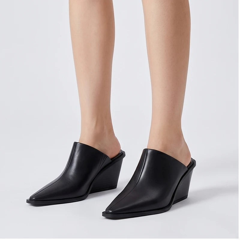 Model wearing black cowhide Valdis Genuine Leather Wedge Mules in studio