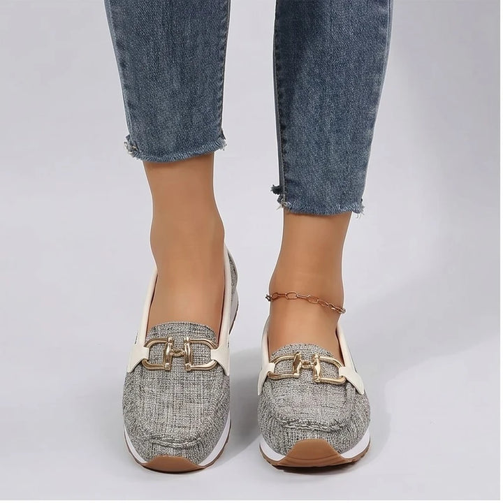 Model wearing Beige metal flat in a studio