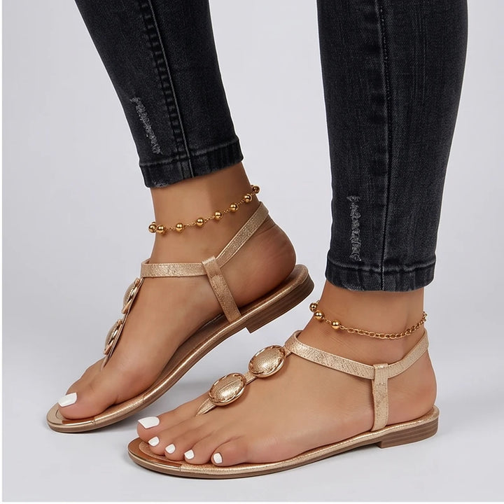 Model wearing Gold Harlow T-Strap Flat Sandals in studio - 2
