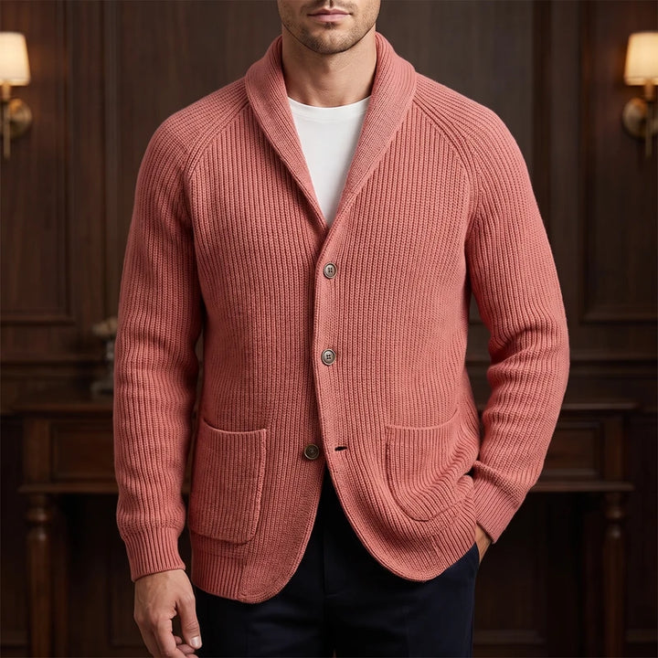 Orange knit cardigan in a dark wood interior