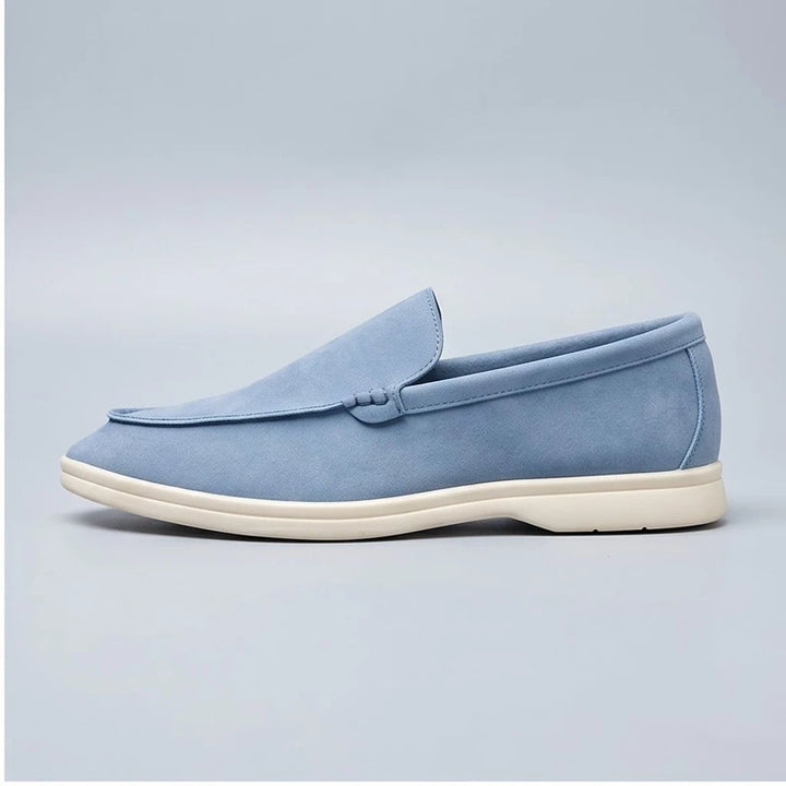 sky blue suede loafers in a studio background - 2