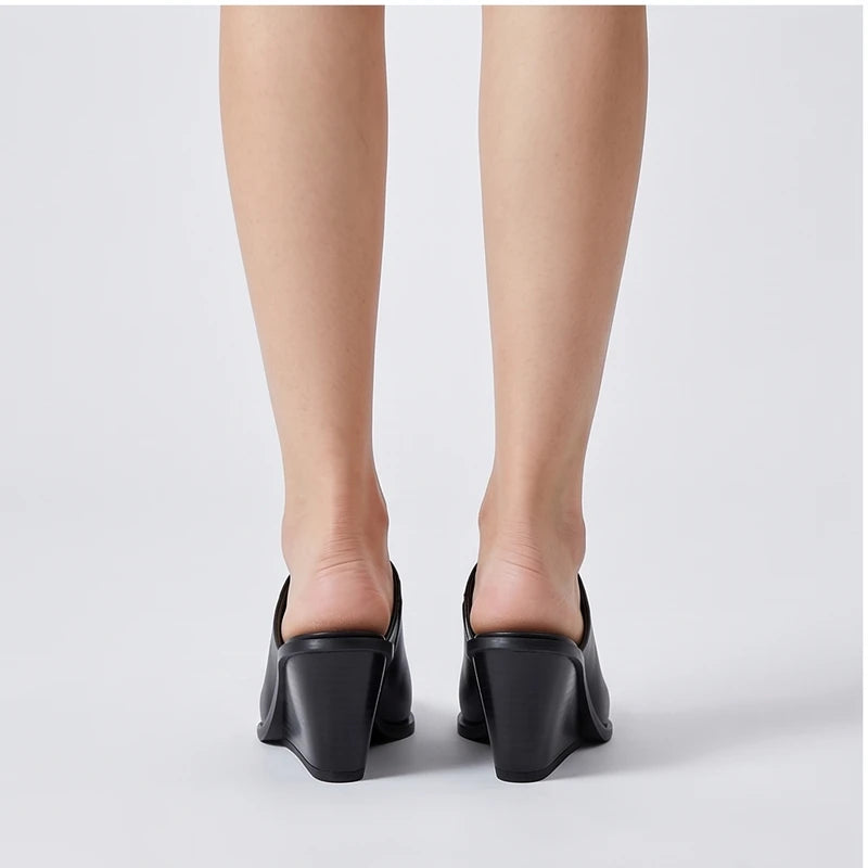 Model wearing black cowhide Valdis Genuine Leather Wedge Mules in studio - 3