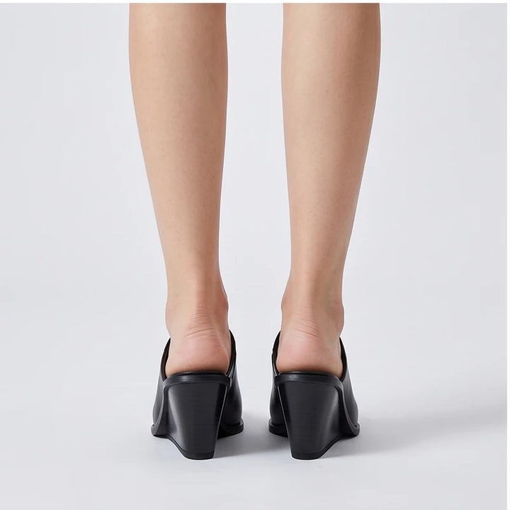 Model wearing black cowhide Valdis Genuine Leather Wedge Mules in studio - 3