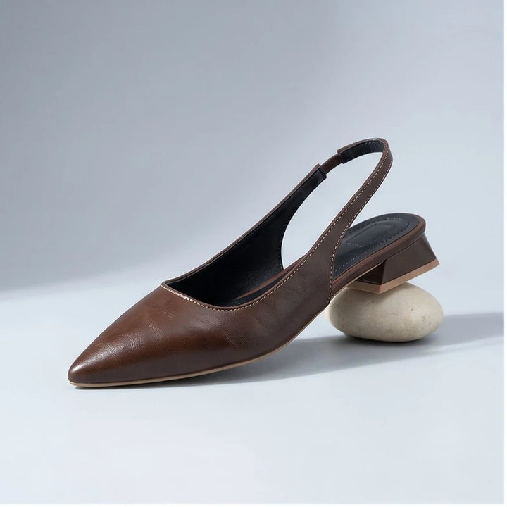 Brown leather flats in a studio background