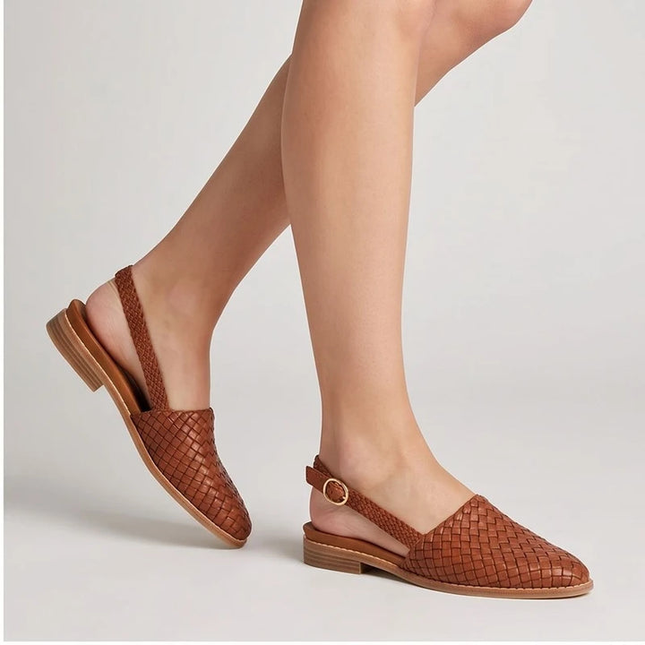 Model wearing Brown woven loafers in a studio