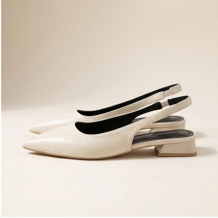 White leather flats in a studio background - 2