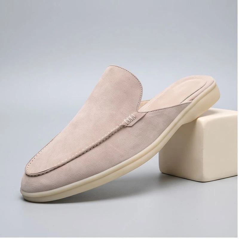 White suede mules in a studio background