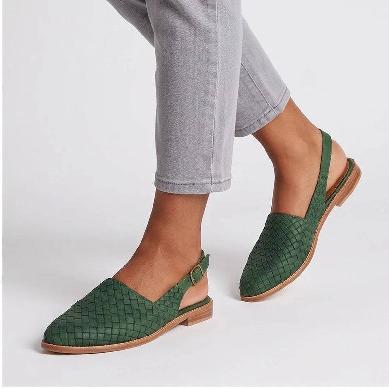 Model wearing Green woven loafers in a studio