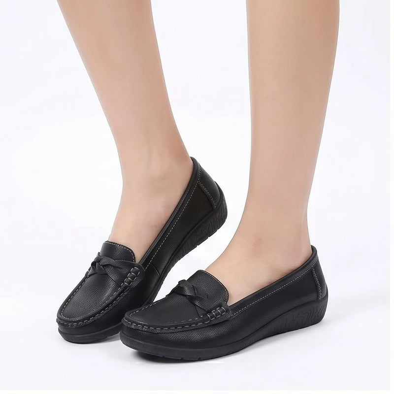 Model wearing Black leather flats in a studio