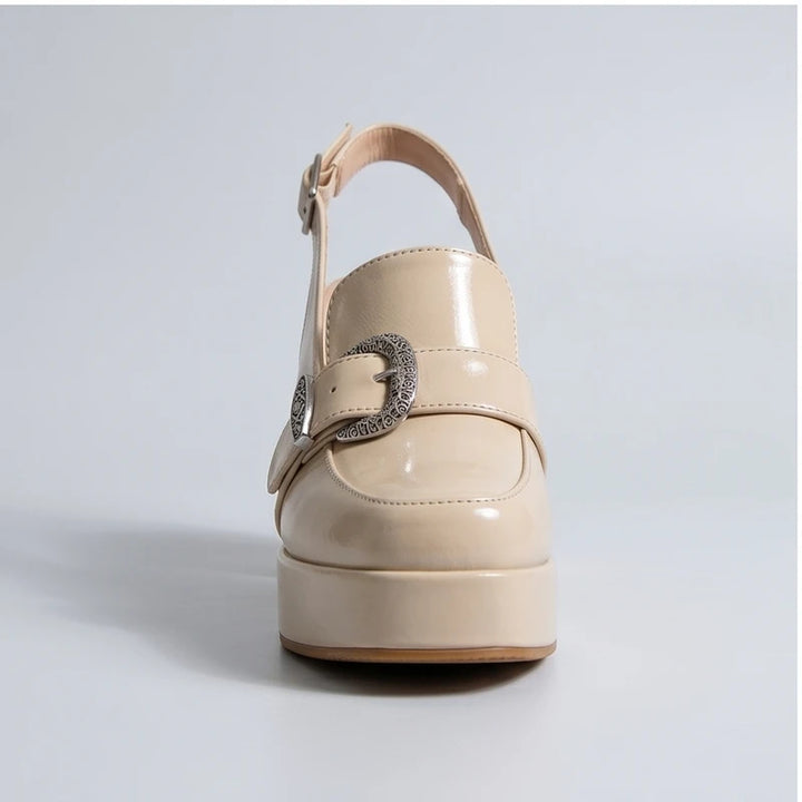 Beige patent leather Belinda platform slingback heels with ornate buckle.