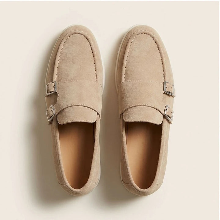 Tan suede double monk strap loafers with silver buckles.