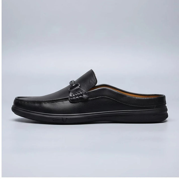 Black leather mules in a studio background - 2