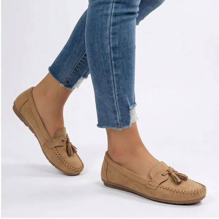 Model wearing Apricot loafers in a studio - 2