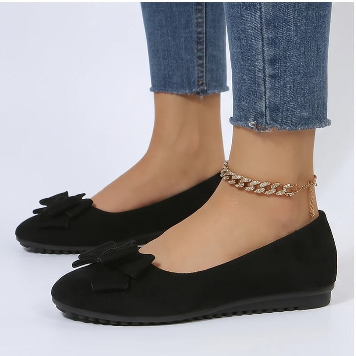 Model wearing Black Briony Suede Bow Flats in studio - 3