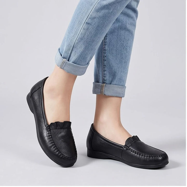 Model wearing Black leather loafers in a studio