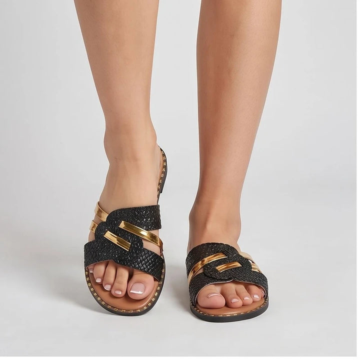 Model wearing Black slippers in a studio