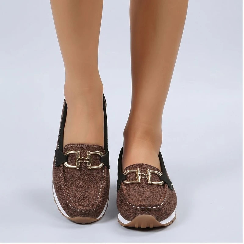 Model wearing Brown metal flat in a studio