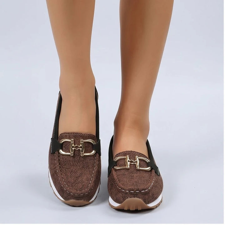 Model wearing Brown metal flat in a studio
