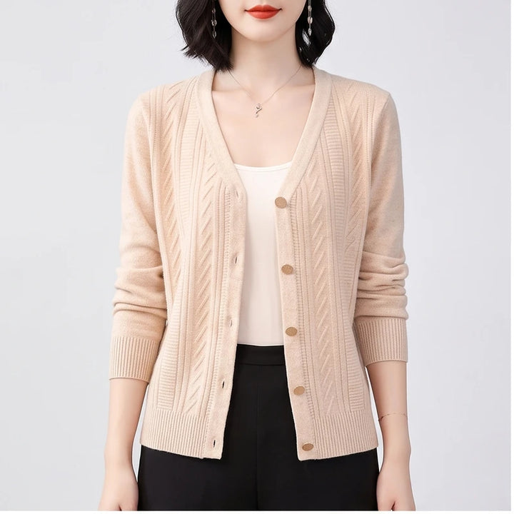 Model wearing apricot knitted cardigan in a studio