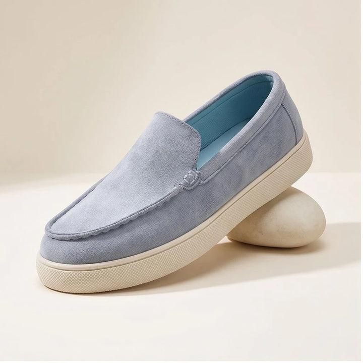 Blue1 suede loafers in a studio background
