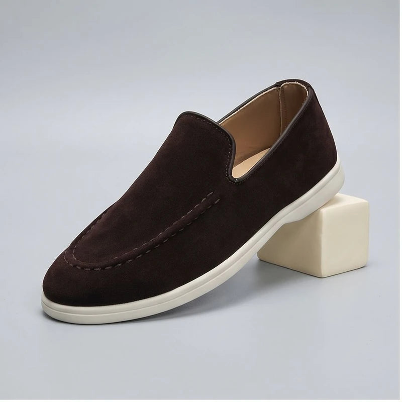 Chocolate suede loafers in a studio background