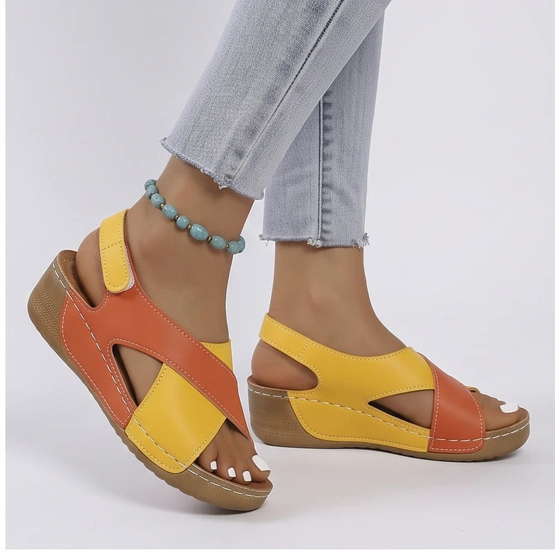 Model wearing Orange sandals in a studio