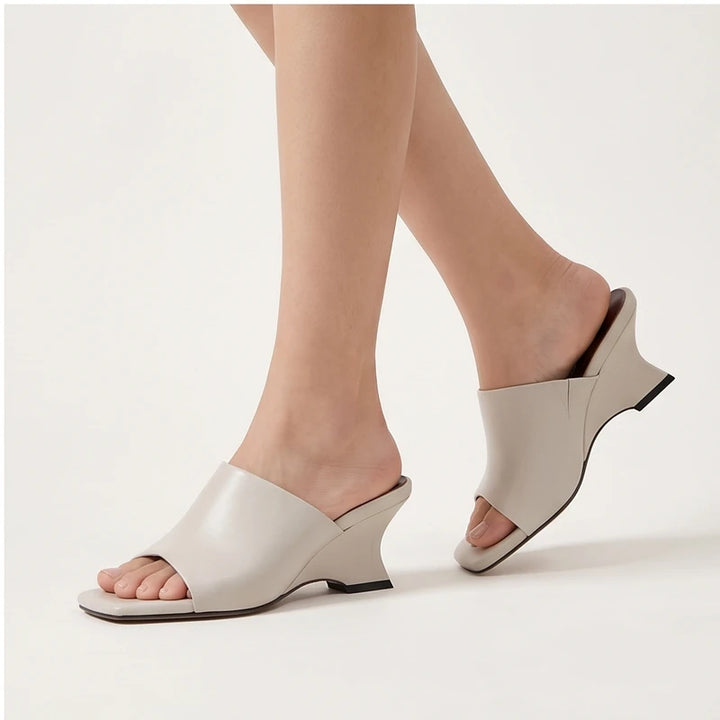 Model wearing White Olympia Genuine Cowhide Leather Heeled Mules in studio - 4