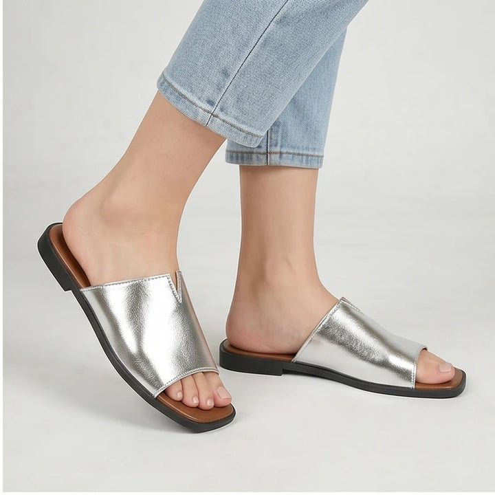 Model wearing Silver Shiny Metallic Flat Slides for Women Square Toe Open Toe Lightweight Comfortable Summer Beach Casual Daily Walking Shoes in studio - 2