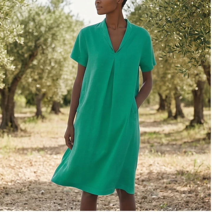 Model wearing Green Women's Short-sleeved Cotton and Linen Dress V-neck Loose Large Size Casual Vacation Street Long Dress with Pockets outdoors