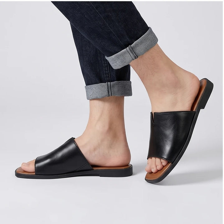 Model wearing Black Keaton Genuine Leather Slide Sandals in studio - 2