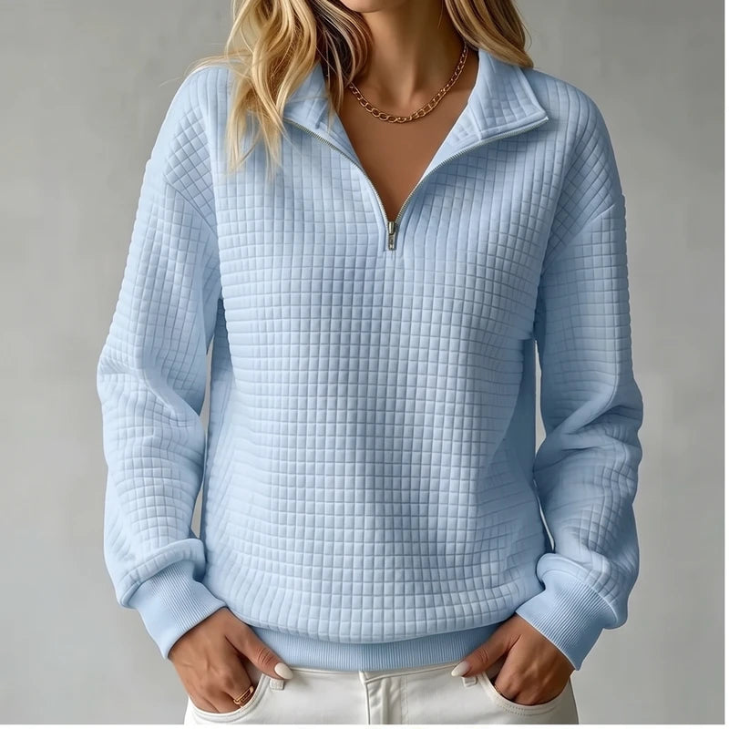 Model wearing Blue knit pullover in a studio