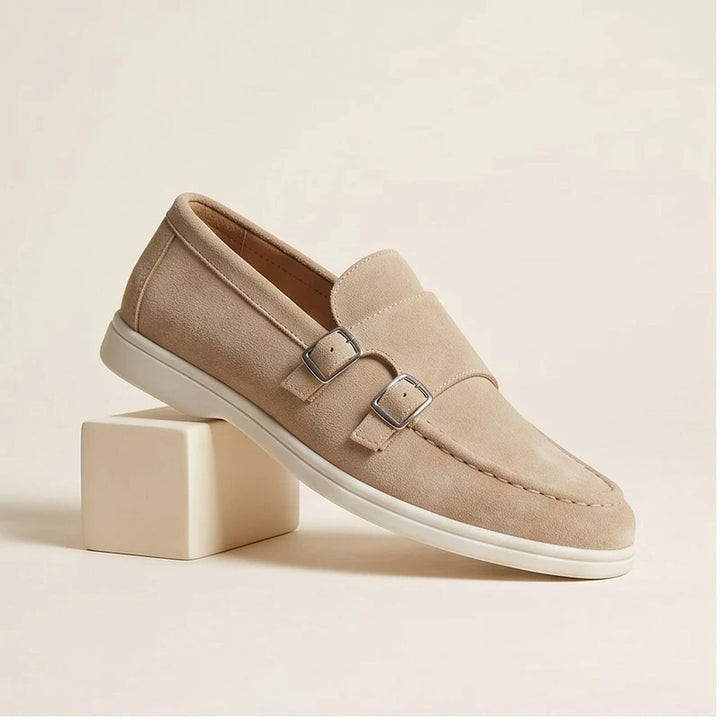 Tan suede double monk strap loafers with a white sole.