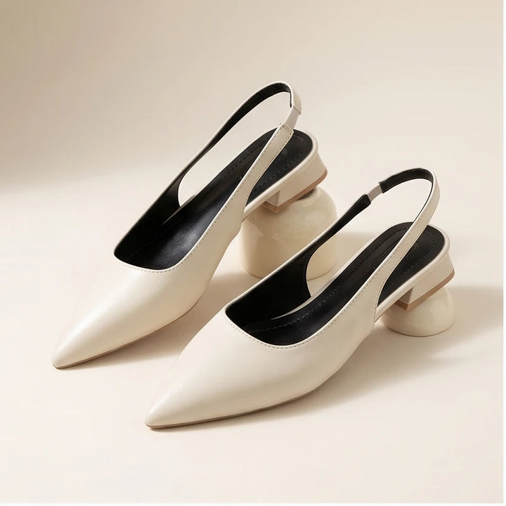 White leather flats in a studio background