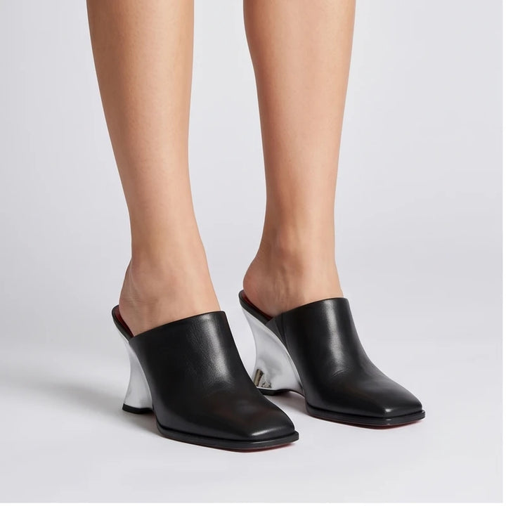 Model wearing Black Olympia Genuine Cowhide Leather Heeled Mules in studio