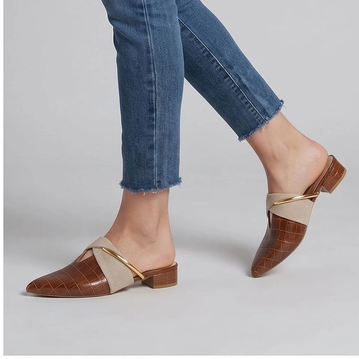 Model wearing Ivory Cream mule in a studio