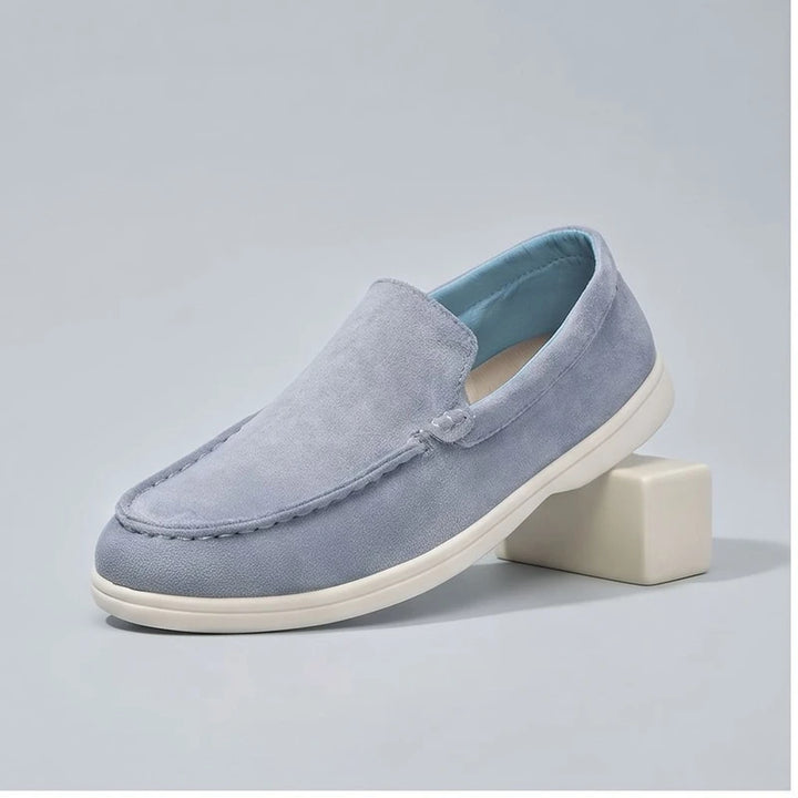 Blue2 suede loafers in a studio background