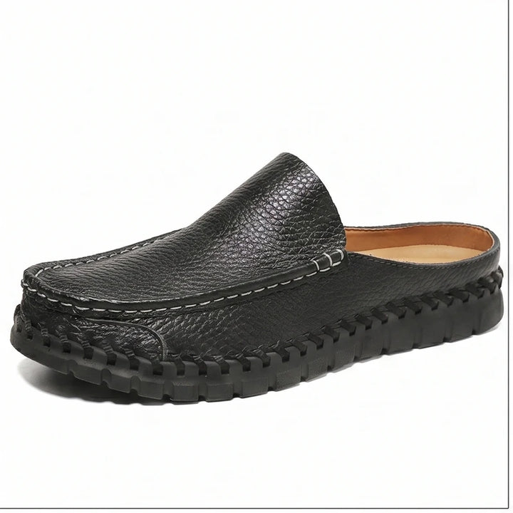 Black leather mule on a white background