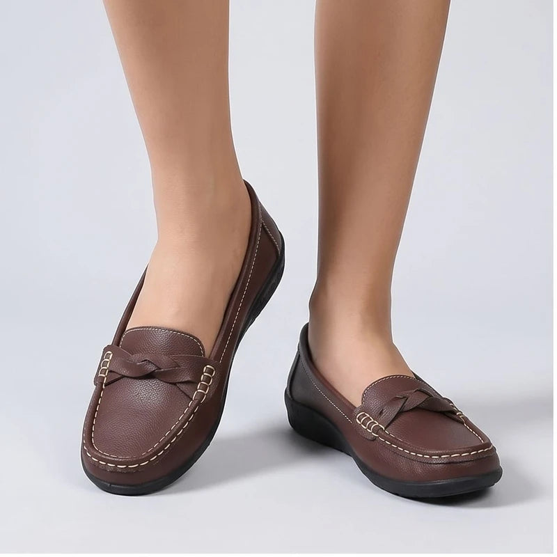 Model wearing Brown leather flats in a studio