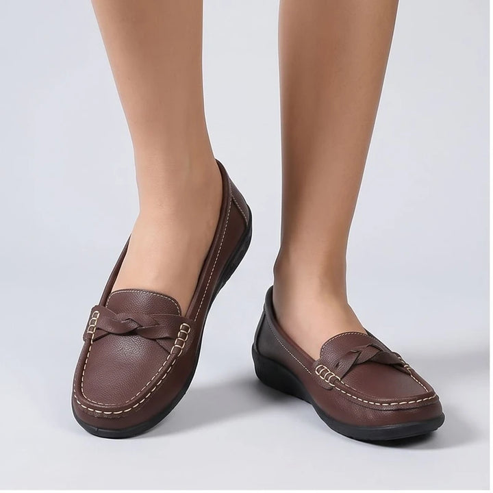 Model wearing Brown leather flats in a studio