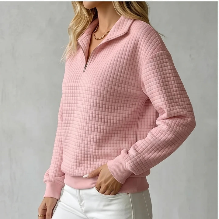 Model wearing Pink knit pullover in a studio