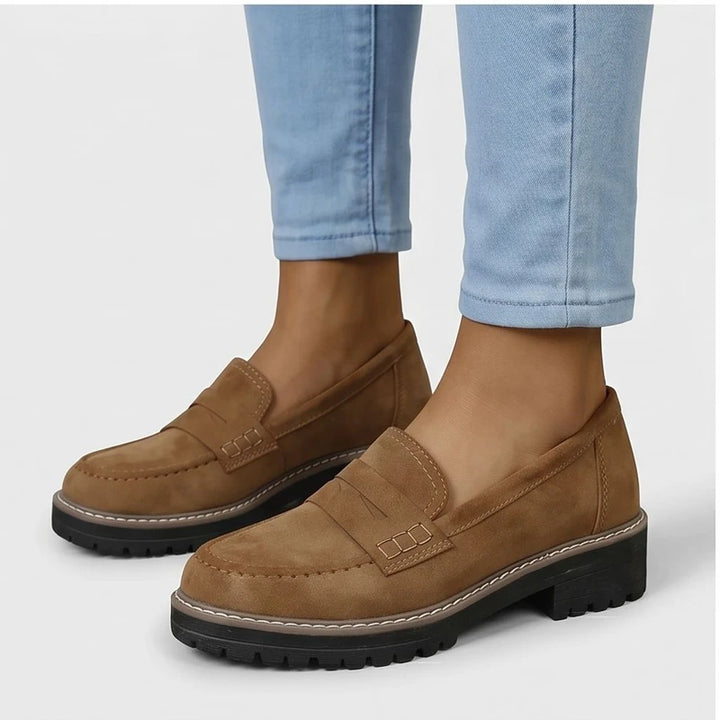 Model wearing Brown Brynn Suede Penny Loafers  [needs new images] in studio - 2