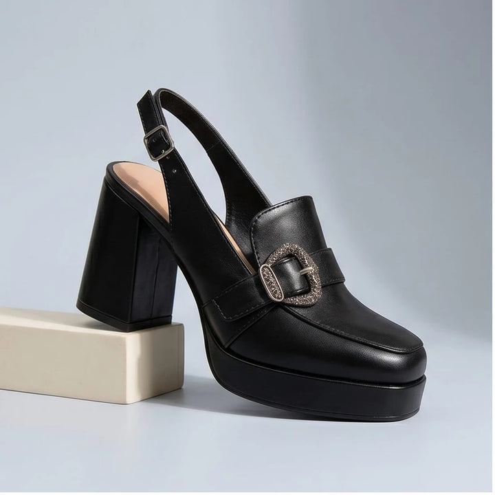 Black leather heels in a studio background