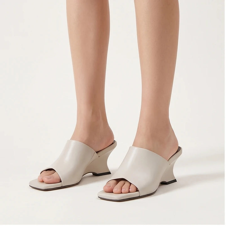 Model wearing White Olympia Genuine Cowhide Leather Heeled Mules in studio