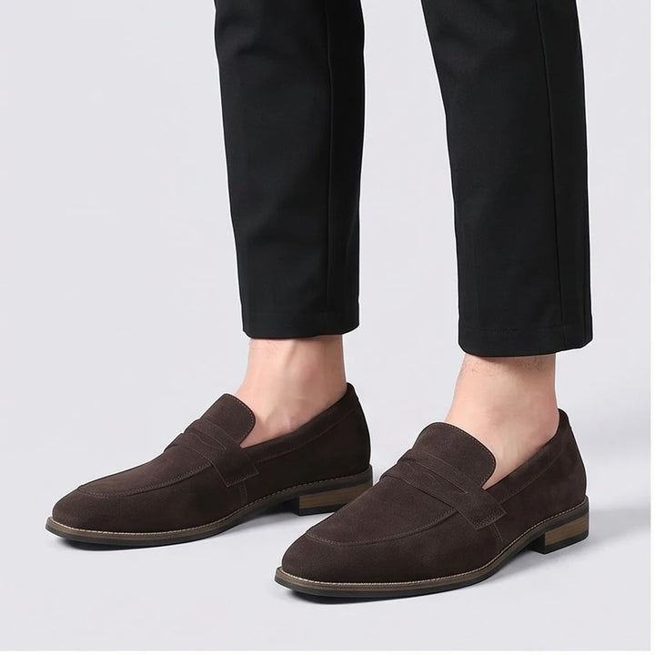 Model wearing Brown suede loafers in a studio