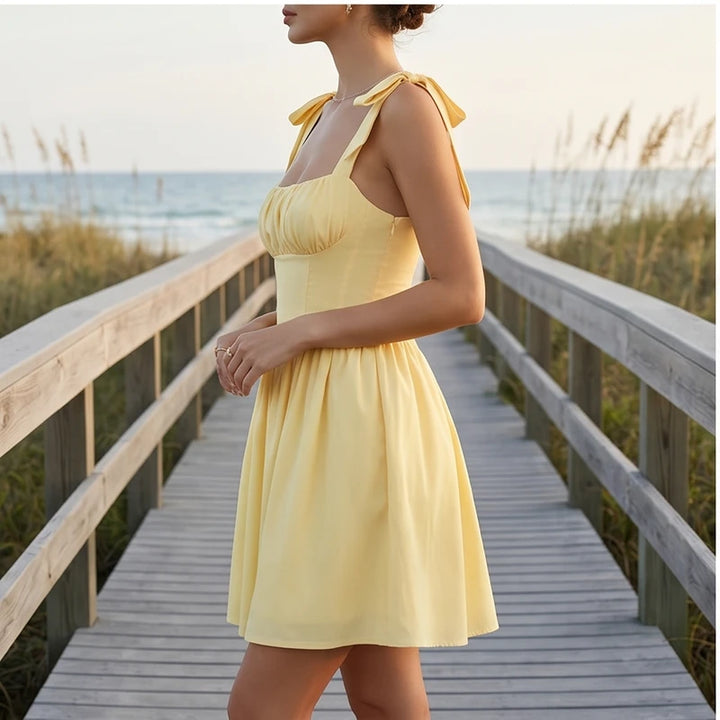 Model wearing S Solara Tie-Strap Yellow Mini Dress outdoors - 3